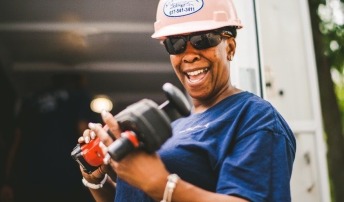 Woman with tool and hard hat